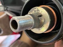 The two small conical collars that are compressed by the nut are shown here still engaged to the spline 