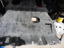 Photo shows the 5" diameter hole cut in the undertray with the tray removed.