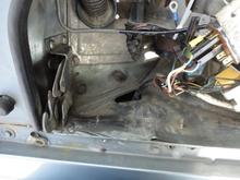 Triangular hole below the starter relay with rubber grommet removed