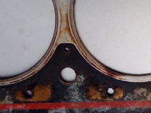 Similar discoloration on bottom of head gasket around cylinder three sealing surface.