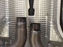 Stock front pipes outlet to center section. Notice the reduced pipe ends and a raised bead. Kind of a pain to work with, but we managed.