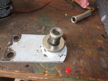 The tongue shaped piece, note hump UPWARDS, at the bottom. Then the special washer (mine being a beautifully made stainless piece run up by Louis the Lathe King). This is indented to allow the tubular spacer, next item up, to sit in an indent. On top is another special washer which is rounded on its edge. This MUST be in top of the tubular spacer (the Jaguar diagram showing it below is WRONG).