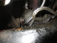Runs under the engine mount bracket and up to th pump
