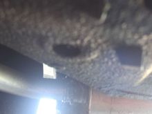 The Sump Tank Drain Tap is Concealed by a Rubber Grommet just forward of the Rear Silencer/Muffler
