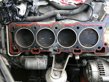 Left side of engine with cylinder head just taken off.  And yes that is a bolt, that I had to saw off to remove the head.  But look at the gasket....