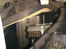 Rotate cover towards fender to unlatch from bottom wire spring. (Pull on cover while rotating)