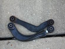What the two arm look like side by side.  The orientation is correct.  The new arm (bottom) is from a Volvo S40/V60.  I bought mine on E-bay for $112.50 delivered to my house.  Install takes all of 30 minutes as long as the bolts cooperate.