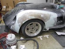 Our goal over the past several weekends was to finish the rough shape of the fenders and then cover the body with one final layer of carbon fiber to give it strength.

First step was to work on and develop the front fender shape and integrate the large flare into the overall shape of the car.  We wanted a wide look without disruption the classic profile of the Lister/Jag style.