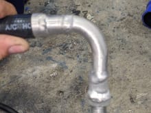 Suction line elbow to avoid kink in hose
