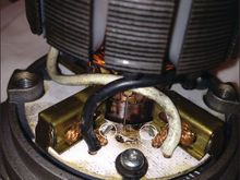 This photo shows where the original TVS was. You can see the burn spot where the leaked oil burned off and the stubs left from where I clipped the leads. The TVS was already split and that actually made getting the snips in there easier as I was able to bend up the two pieces and snip them both close to the bottom.