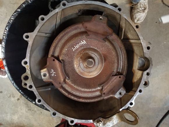 I bolted a bracket on the bellhousing and use an rngine hoist to get in the garbage can wherr I stand it on its end. You will find it a lot easier to aline the clutch disc when you put everything back together.