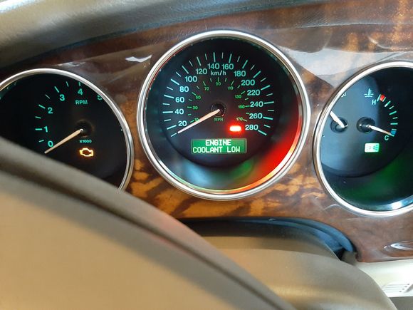 "Low Coolant" warning even with full tank. This was intermittent for a year, then stayed on for a week. Decided to try the 'long-finger' technique that is suggested in this post to jiggle the magnet free. I could feel an opening at the bottom of the sensor shaft and it felt like something was spinning in the shaft, then it disappeared. Warning light went out right away.