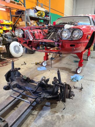 Raison d'etre.  This was last night.  Notice I spun the car around.  Worked like a charm.  I wanted to use my forklift to support and lower the sub-frame.  I might have to install my long forks to remove the IRS.  