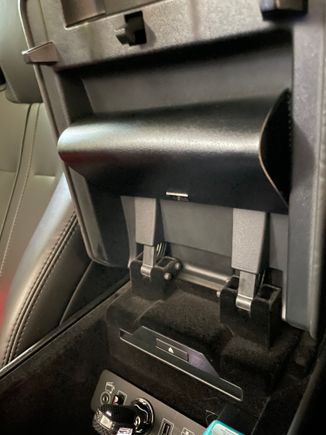 My sunglasses case happened to fit perfectly under the armrest and secured using some double sided tape. Convenient and out of the way. 