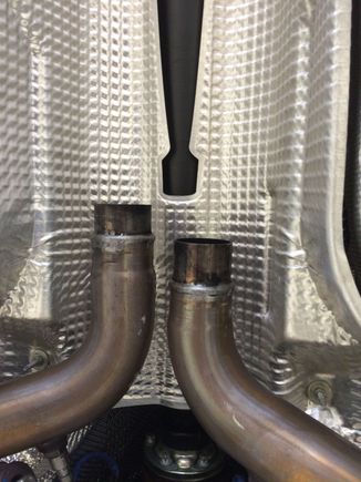 Stock front pipes outlet to center section. Notice the reduced pipe ends and a raised bead. Kind of a pain to work with, but we managed.