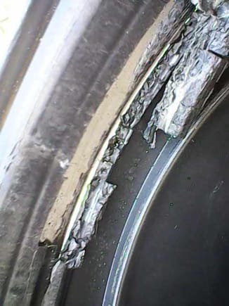 Close up of the hard, breaking plastic tube looking onto the SS clamp.