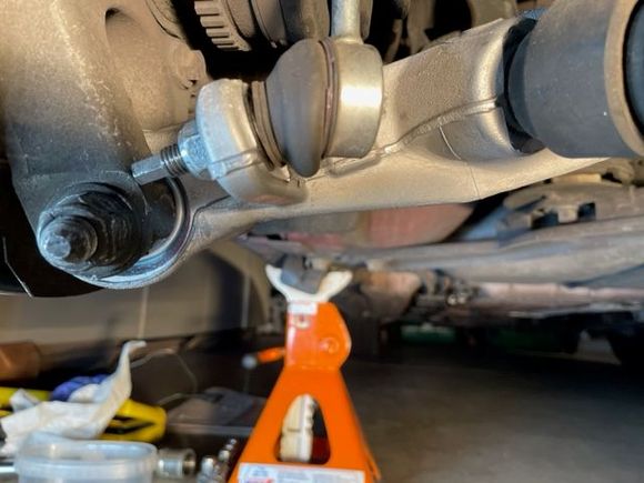 Lower control arm attached to spindle at left; bottom of sway bar link in foreground.