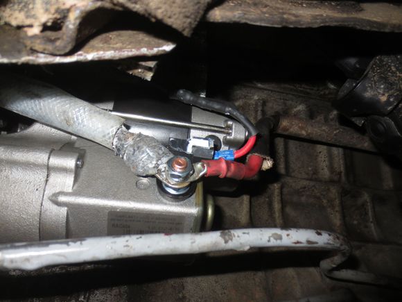 Silver cable is from the firewall post, red cable from the alternator, small red wire with blue connector from the starter relay. The relay wire has been cable tied to the firewall cable to stop it flogging around as shwon in the next photo