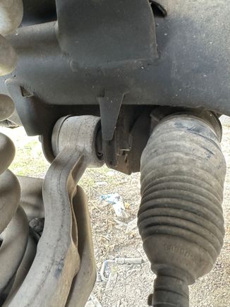 Pic of left side lower contol arm on a 2000 X308 at a local pull and pay yard this weekend. Shows bolt inserted from the rear, just ahead of the steering linkage.