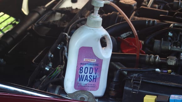 Old Shower Gel Bottle with Pump Dispenser to Top up the Power Steering Fluid the Easy Way