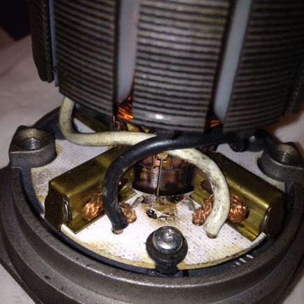 This photo shows where the original TVS was. You can see the burn spot where the leaked oil burned off and the stubs left from where I clipped the leads. The TVS was already split and that actually made getting the snips in there easier as I was able to bend up the two pieces and snip them both close to the bottom.