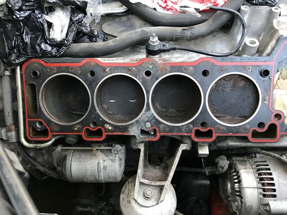 Left side of engine with cylinder head just taken off.  And yes that is a bolt, that I had to saw off to remove the head.  But look at the gasket....