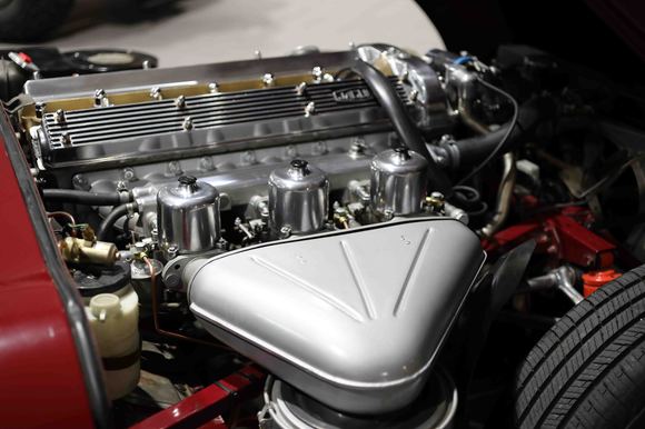 The black crinkle paint on the covers have been polished. Chromed high output alternator, triple CUs, cam valley painted Jag gold, electronic distributor, NGKs, battery cutoff, Koni shocks all around.