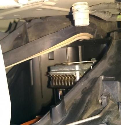Rotate cover towards fender to unlatch from bottom wire spring. (Pull on cover while rotating)
