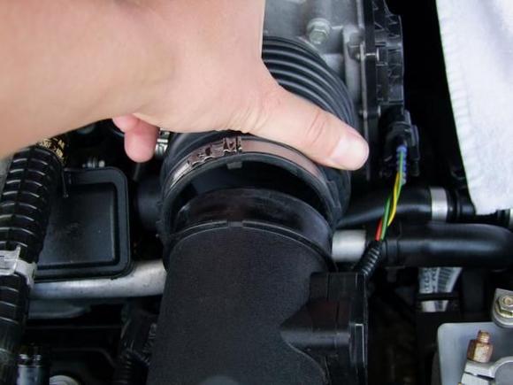 Step 2
I was able to slide off the coupling from the air box without undoing the band.