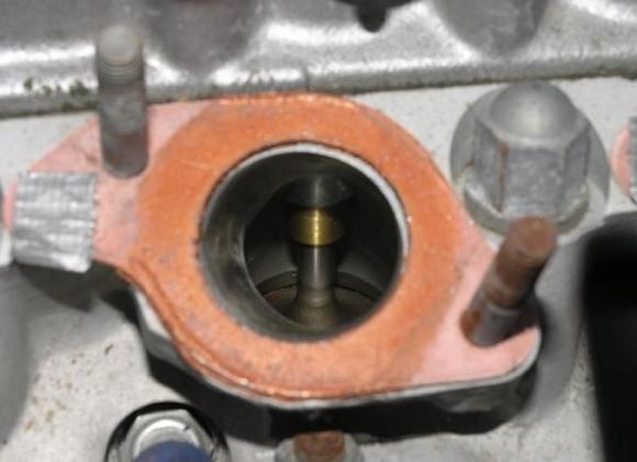 Looking inside the intake port of cylinder 6B on my GTJ motor. The port seems to be slightly larger and better shaped than a stock port. However, the opening is not enlarged to the same size as the intake manifold gasket (a process referred to as &quot;port matching&quot;), the full bronze valve guide is intact, and although the port material surrounding the valve guide has been shaped, there is still a good bit of it remaining in the port.