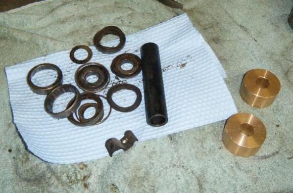 All that crud on the left... replaced with the two brass bushings on the right. Oh man, so much easier to deal with.