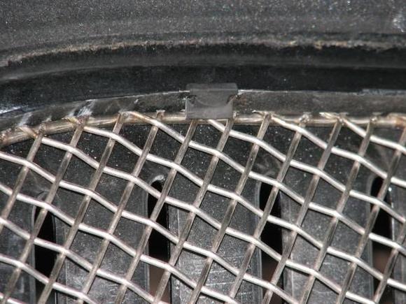 Close up of the clip holding the grille in place