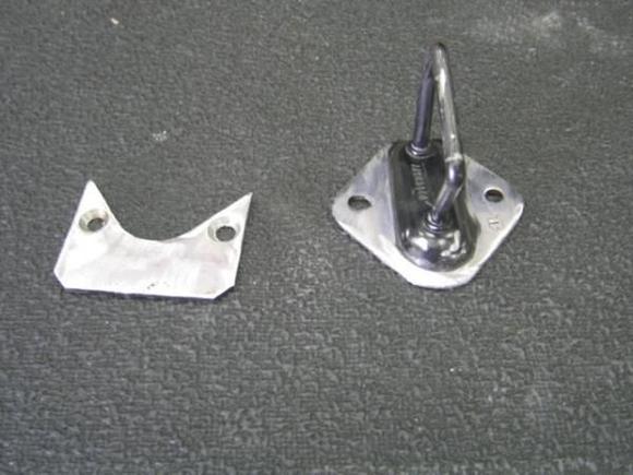 Now that the trunk had hinges and a strut to hold it up, it needed a latch.  Not wanting to invent everything on this car, i cheated and raided the corvette parts bin for a late model electric latch assembly.  unfortunately, the "latch" part could in no way be mounted to the underside of the trunk lid.  that started another little "diversion"...  here is the factory trunk latch with the "adapter plate" i cut out of 16 gage steel.