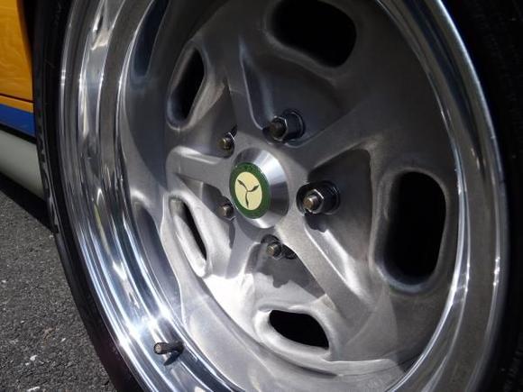 I machined the hub for the Lister badge with a much lower profile than the "growler" center caps.  the lower profile center caps give the center of the wheel a nice look.