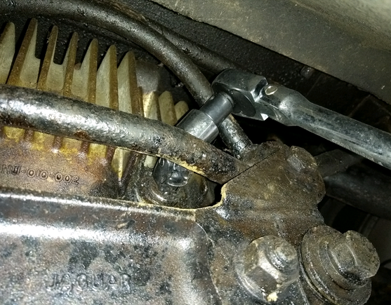 Using a u joint to free the differential oil fitting