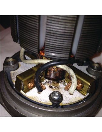 This photo shows where the original TVS was. You can see the burn spot where the leaked oil burned off and the stubs left from where I clipped the leads. The TVS was already split and that actually made getting the snips in there easier as I was able to bend up the two pieces and snip them both close to the bottom.