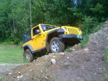 trying to climb a dirtpile full of rocks. Almost tore the splash guard off. haha