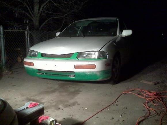 Another quick pic during mock up, fully gutted front clip, convershion lights, coil over lowering strut kit, lower ground lights, lower green strip w/mazda race decals on either side, center grill removed w/smoothed and painted head light trim, for  now aluminum kong rims w/195/55/15's until done with build, few more hidden fabrications.