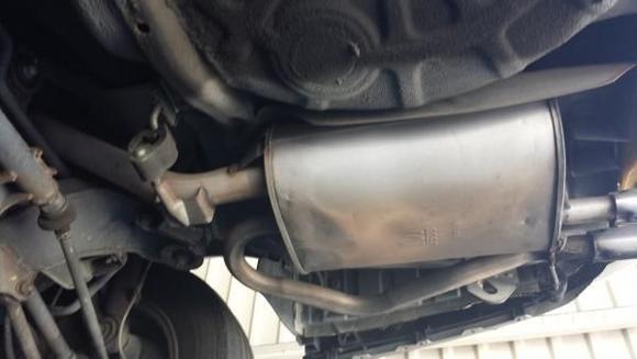 20140708 130808
This is the premuffler before it was removed. There is a hole on the top side that is as big as the muffler. The sheet metal skin on the top of the body is separating from the seams on either end, essentially providing NO muffle effect as all the exhaust exits the gaping hole.