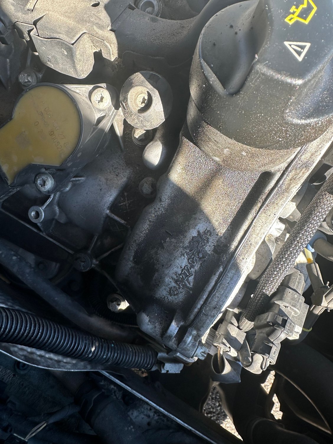 Next to engine oil cap