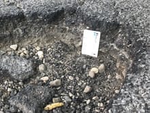 pothole for with card for scale