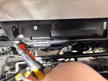 Shows the second screw near the center console. 