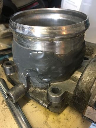 I had a friend weld about 7 or 8 small spots (called tack welds) around the throttle body to connect a bit of aluminum intake pipe with a lip. A lot of heat can get transferred from the welding process into the throttle body and damage it, so I wanted to avoid anything more than a few quick spot welds 

Afterwards I sealed up the new throttle body modification with a healthy layer of jb weld 