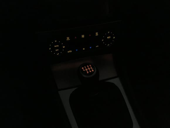 This photo exaggerates the difference.  It captures the color of the shift knob fairly accurately, but it makes the rest of the dash illumination appear too yellow.