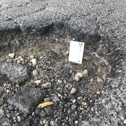 pothole for with card for scale