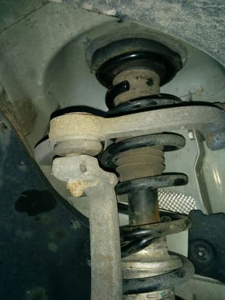I plan to disconnect this ball joint, loosen but do not remove the 2 nuts holding the arm and then swing the arm upwards to allow the strut to come down and tilt.