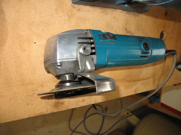 Angle grinder with thin cut off disc attached.