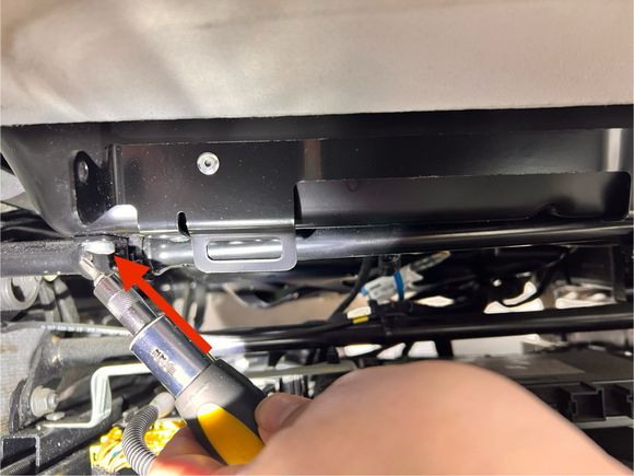 Shows the second screw near the center console. 