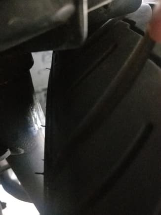 Space between wheel and strut from back end of tire. 