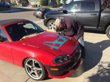 The first cut is the deepest.  I'm new to this angle-grinder thingy, so I was a little trepidatious, to say the least.  Blanket under the hood protects the engine bay.